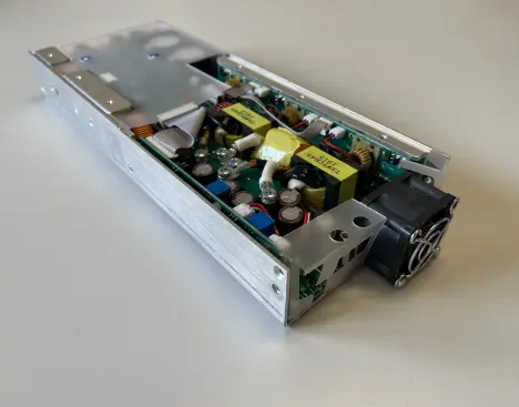 Internal assembly of a custom power supply with cooling system.